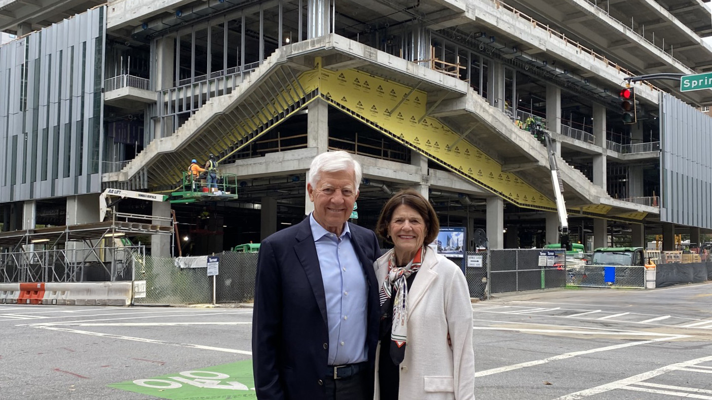 Bill and Penny George proudly standing in front of the George Tower, currently under construction